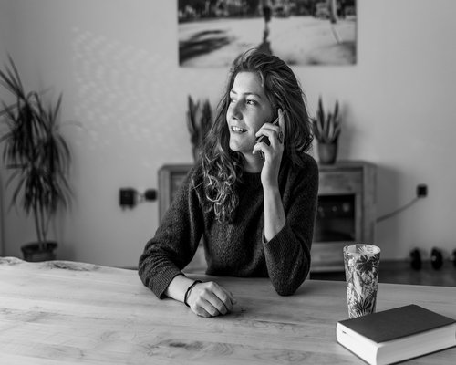 Woman taking a break stretching her arms at her home desk