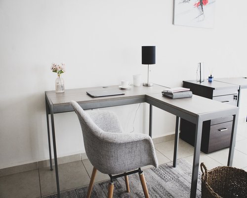 Clean and organized workspace with a monitor positioned directly in front of the chair