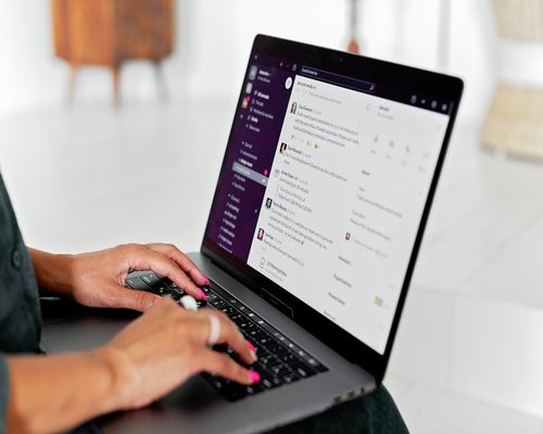 Person typing an email on a laptop computer